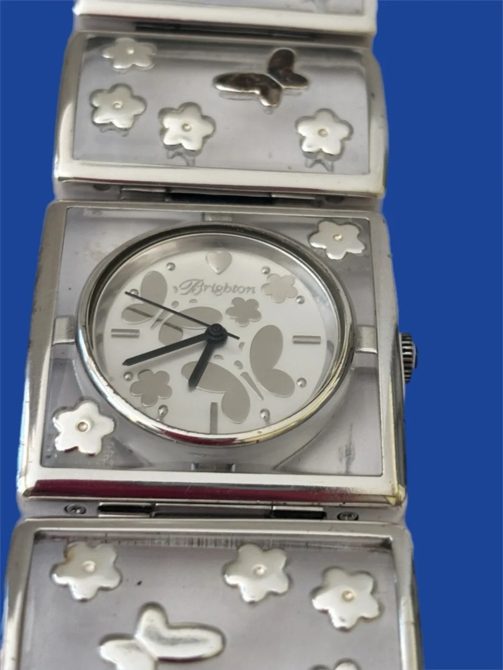 Brighton Gainesville watch features a design silver-tone butterflies & flowers.